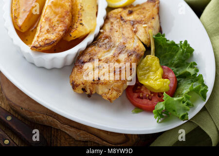 Grilled fish with roasted potatoes Stock Photo