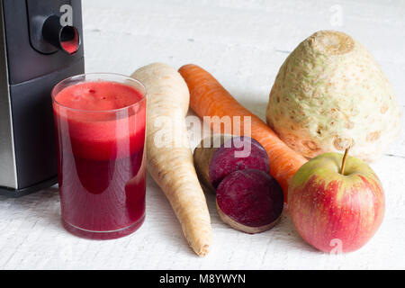 Glass of organic juice with raw fruit and vegetables and juicer Stock Photo