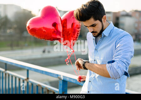 Sad man waiting for date on valentine date Stock Photo
