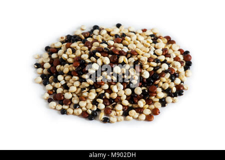 Mixed raw quinoa (Chenopodium quinoa). Red, black and white seeds isolated on white background Stock Photo