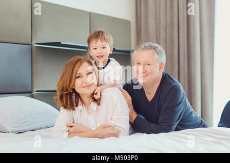 Grandmother and grandfather with grandson in a room in front of  Stock Photo