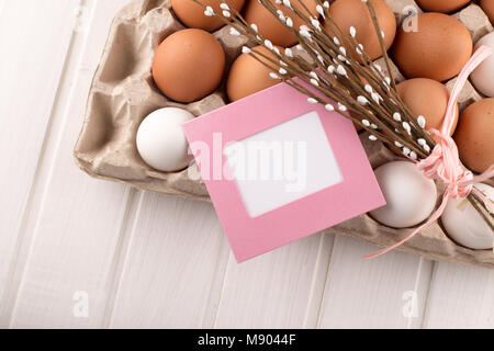 Easter Eggs in Nest from Top View Looking Down on White or Gray Rustic Wood Background with room or space for copy, text, words happy easter Stock Photo