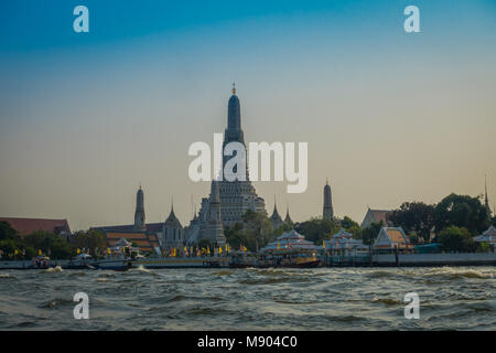 Amazing outdoor view of wat Arun Bangkok Thailand, the Temple of Dawn, on The Chao Phraya river in the horizont