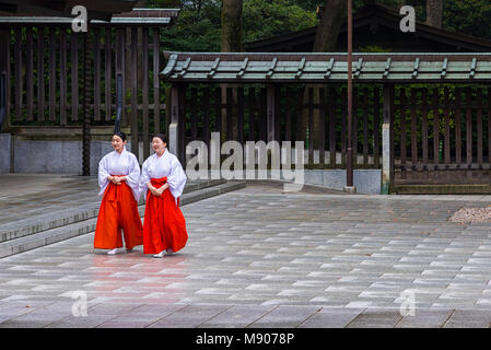 Tokyo, Japan - April 21, 2014: View of two Mikos in Meiji Shrine. In Shinto, a miko  is a shrine maiden or a supplementary priestess Stock Photo