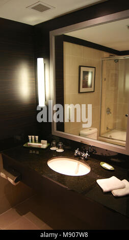 SINGAPORE - APR 2nd 2015: Modern dark bathroom interior design in a luxury hotel Stock Photo