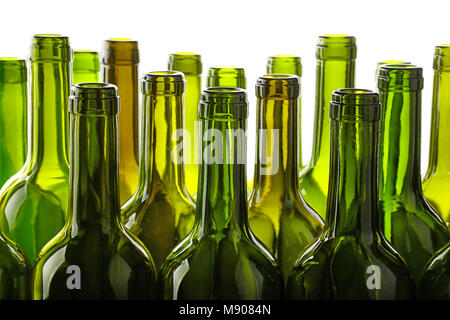 Close up group of many empty washed green glass wine bottles in a row isolated on white background, low angle side view Stock Photo