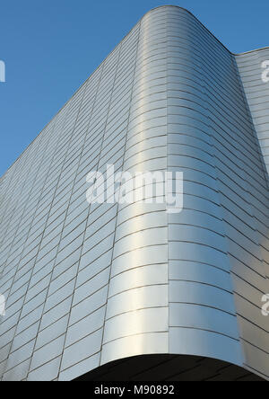 Sunlight reflecting off curved aluminium rainscreen cladding on corner ...