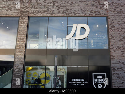 JD Sports logo on store front window, modern retail building with glass and brick facade in the rock triangle development, bury town centre, uk Stock Photo