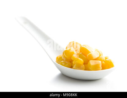 Corn seeds in ceramic spoon isolated on white background. Stock Photo