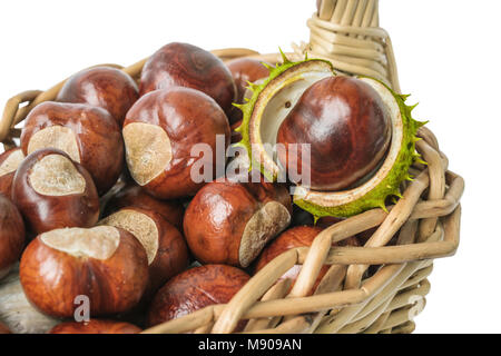 Chestnuts in wicker basket on white background Stock Photo