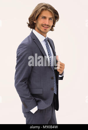 Elegant young handsome man posing in fashionable suit, looking at camera. Studio shot. Stock Photo