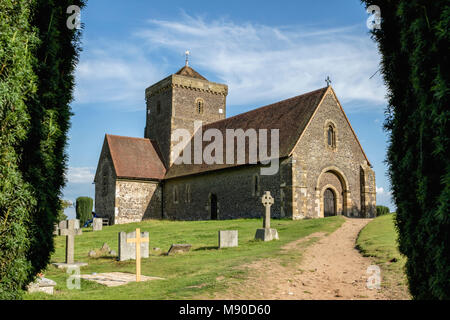 Framed view of church approach and graveyard on St Martha's hill on a sunny day with natural path and pruned trees Stock Photo