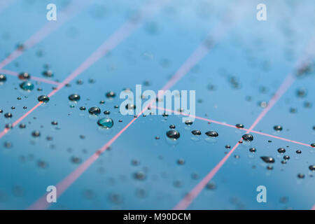 Pattern of water drops in a shiny metallic surface with table reflections Stock Photo