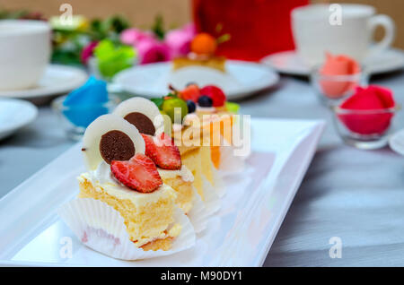 Delicious cake on plate on table Stock Photo