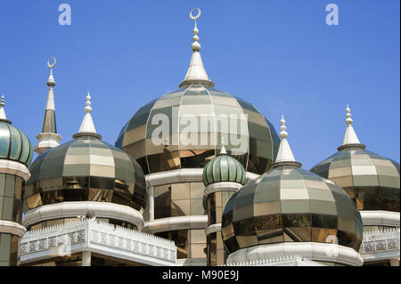 The Crystal Mosque (Masjid Kristal) in Koala Terengganu, Malaysia. Golden minarets made of steel and glass, sparkle in the sun against a  blue sky Stock Photo