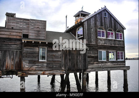 Timber stilt house sits over water at Seaport Village in San Diego, California. Stock Photo