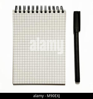 Blank gridded spiral notepad with black pen- isolated on white Stock Photo