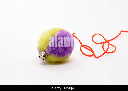 Colored soft ball with red rope on white background Stock Photo