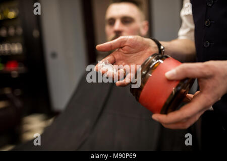Close up portrait of hairdresser hand with hair gel Stock Photo