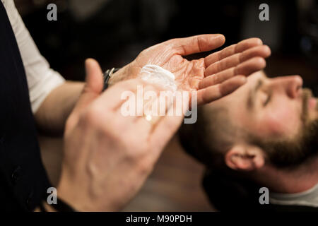 Close up portrait of barber hands rubbing shaving foam Stock Photo