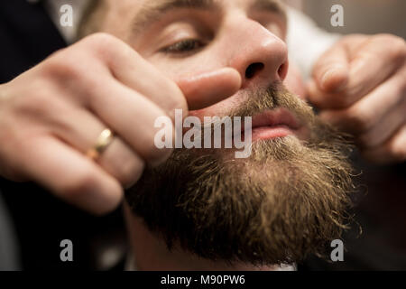 Close up portrait of bearded man having mustache curling up Stock Photo