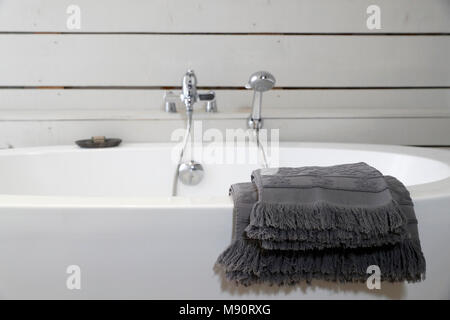 Modern ceramic bathtub with towels. Stock Photo