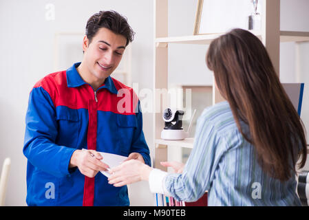 Client getting securty camera installed at home by contractor Stock Photo