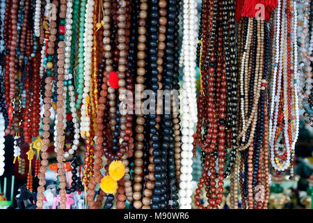 Truc Lam buddhist temple. Various buddhist religious merchandise items on sale. Prayer beads or malas.  Dalat. Vietnam. Stock Photo