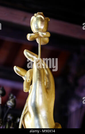 Chua Ho Quoc pagoda.  Golden Shakyamuni Buddha statue. Hand with lotus flower. Close-up.  Phu Quoc. Vietnam. Stock Photo