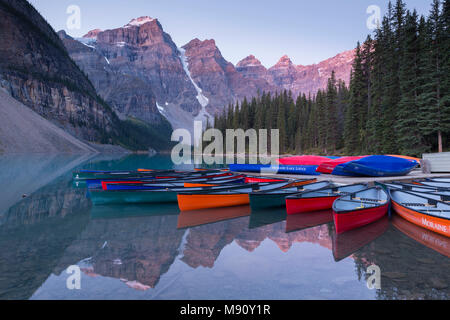 Canoes on Moraine Lake at dawn in the Canadian Rockies, Banff National Park, Alberta, Canada. Autumn (September) 2017. Stock Photo