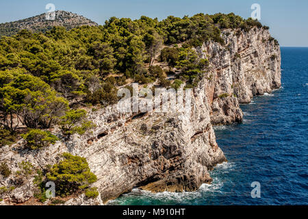 Telašćica cliffs in Croatian island Dugi Otok with Adriatic Sea and distant hill: the rocky Dalmatian Mediterranean landscape near Zadar Stock Photo