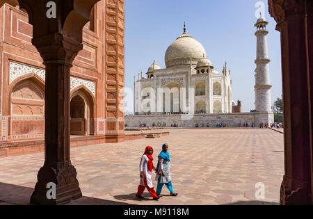 Agra, India - March 03, 2018: Two Indian women at Taj Mahal. The Taj Mahal is an ivory-white marble mausoleum and most popular landmark in India.
