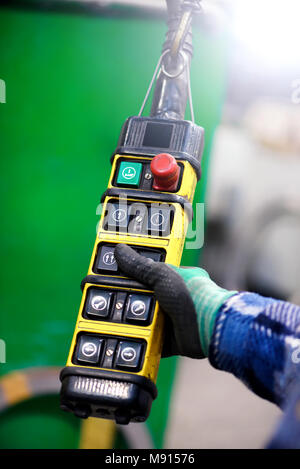 Close up view of hand holding freight elevator controller Stock Photo