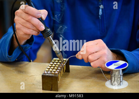 Close up view of worker soldering metal elements in close up Stock Photo