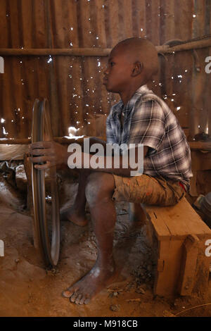 Smithy in Bohicon, Benin. Child worker. Stock Photo