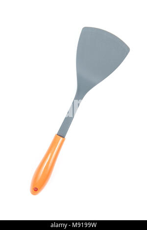 Grey plastic kitchen spatula with orange handle isolated on white background, surface. Kitchen accessory. Stock Photo