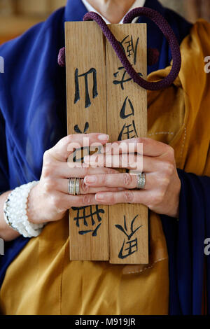 Zen sesshin (retreat). Boddhisatva holding clapperboard. France. Stock Photo