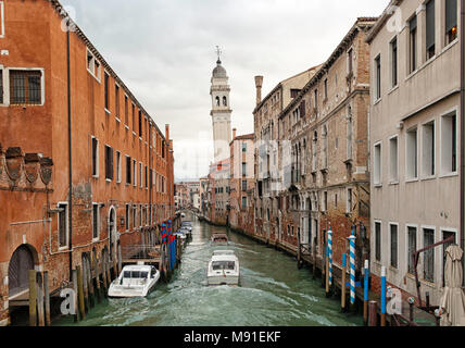 View from a bridge of a typical water canal in the Venetian lagoon with old buildings on the sides. One of the famous canals in Venice Stock Photo