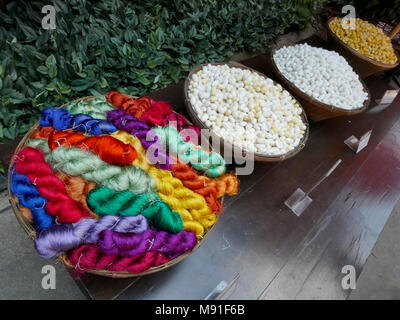 Silk cocoons and brightly colour silk thread at Jim Thompson's House in Bangkok, Thailand Stock Photo