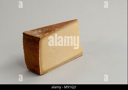 Traditional tete de moine aged mountain cheese of the Alps served with  grapes and walnuts wooden design board with copy space Stock Photo - Alamy