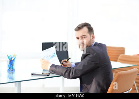 Elegant businessman analyzing data in office Stock Photo