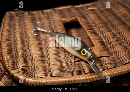 Old fishing lures or plugs, possibly by Woods MFG, on a creel and black  background. From a vintage fishing tackle collection in the UK Stock Photo  - Alamy