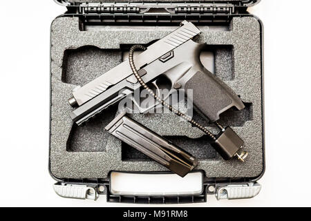 Locked disarmed secured handgun in case white background Stock Photo