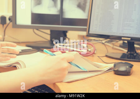 The radiologist looks at the x-ray images on a computer monitor Stock Photo