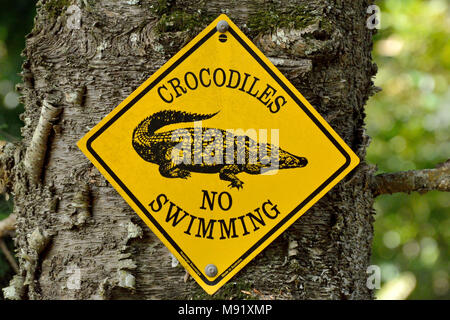 Woombye, Queensland, Australia - December 17, 2017. 'Crocodiles. No Swimming' sign on a tree. Stock Photo