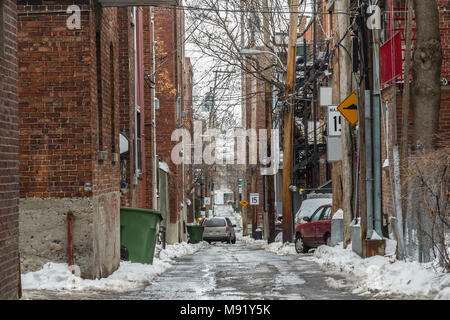 Typical North American residential dead-end alley street covered in snow in a residential part of Montreal, Quebec, Canada  Picture of a dilapidated a Stock Photo