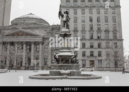 MONTREAL, CANADA - DECEMBER 24, 2016: Maisonneuve monument on place d'Armes square during a snowstorm. It is a monument dedicated to Maisonneuve, the  Stock Photo