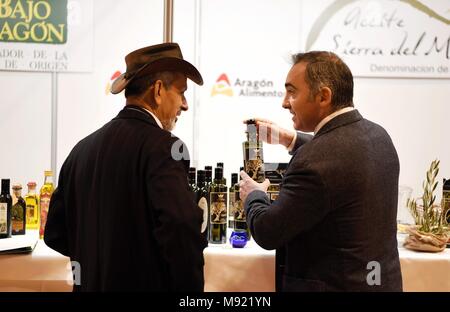 Madrid, Spain. 21st Mar, 2018. People talk about business at the World Olive Oil Exhibition in Madrid, Spain, on March 21, 2018. The World Olive Oil Exhibition was held in Madrid on Wednesday and Thursday. Some 6,000 visitors from more than 30 countries and regions are expected to come to this important international event of olive oil. Credit: Guo Qiuda/Xinhua/Alamy Live News Stock Photo