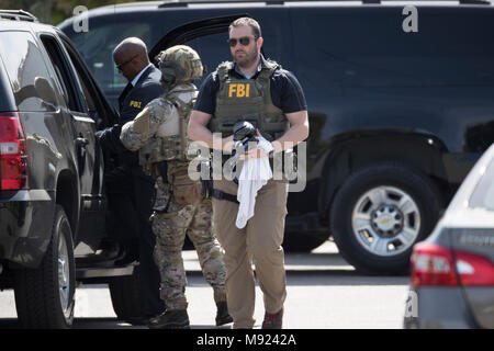 FBI agents help secure the Pflugerville, TX, neighborhood around the home of Mark Conditt, who was the suspected serial bomber terrorizing Austin for three weeks. Conditt killed himself earlier in the day during a car chase as officers closed in. Stock Photo