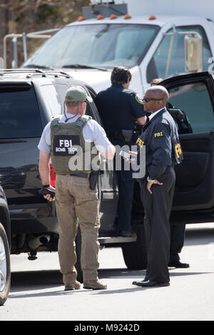 FBI agents help secure the Pflugerville, TX, neighborhood around the home of Mark Conditt, who was the suspected serial bomber terrorizing Austin for three weeks. Conditt killed himself earlier in the day during a car chase as officers closed in. Stock Photo